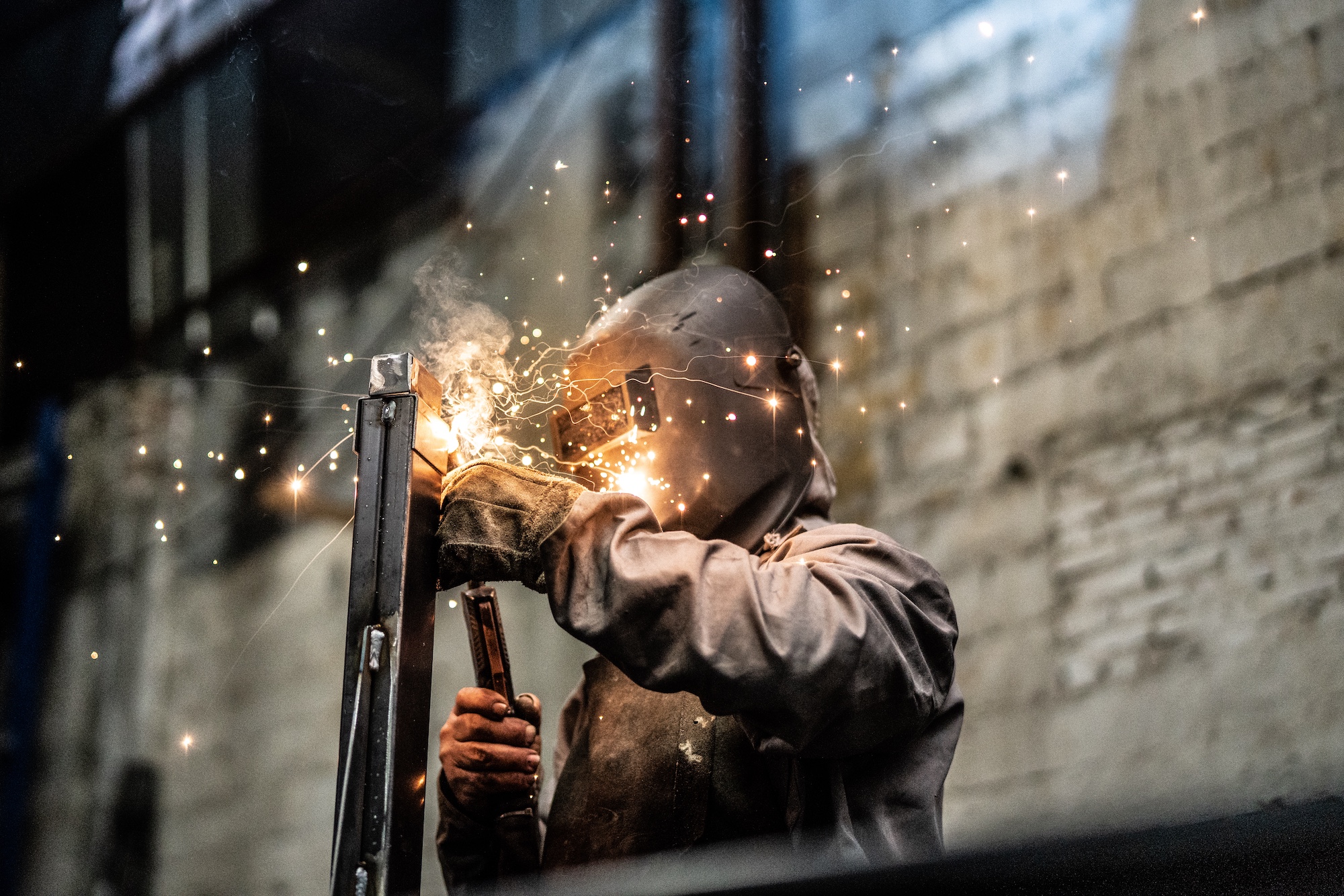 A person welding with sparks flying.