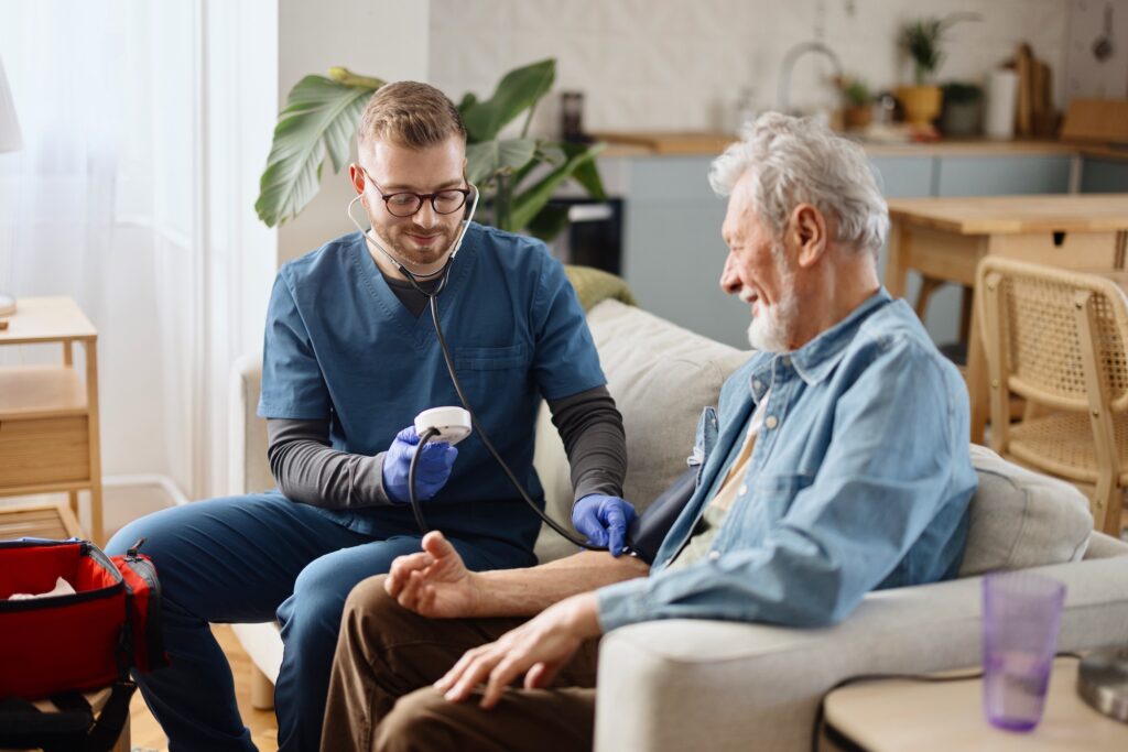 Caregiver measuring the blood pressure of a patient